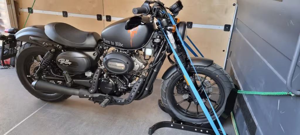 Black motorcycle secured in the van